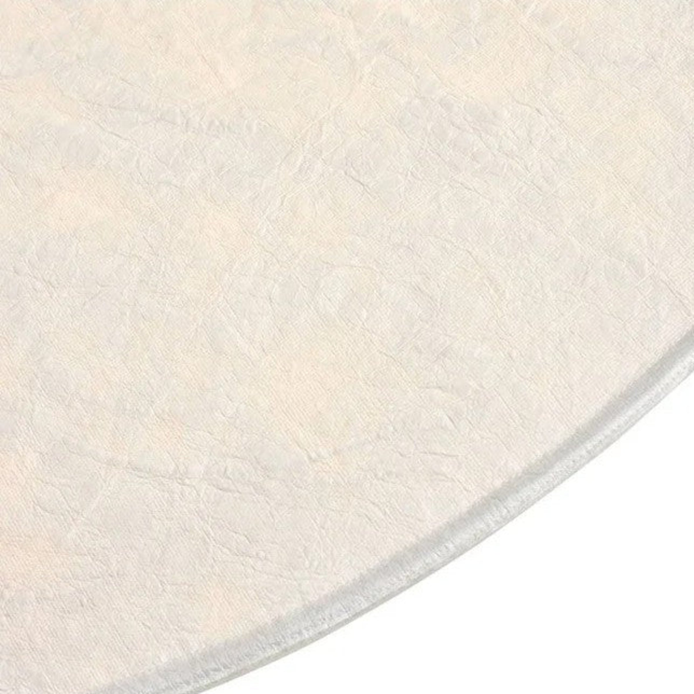 Round white rug with a textured surface on a white background