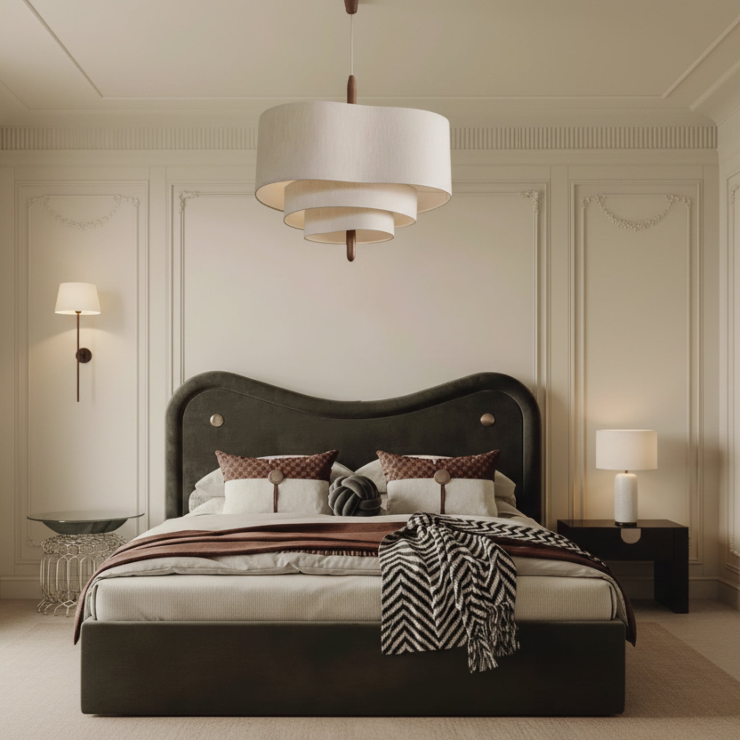 Neatly made bed with decorative pillows and a lamp hanging above in a bedroom setting.