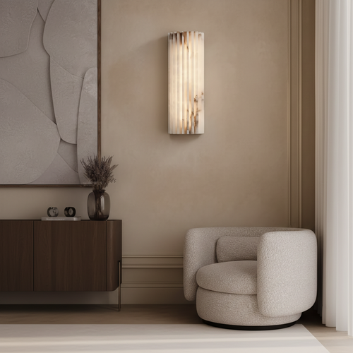 Modern wall sconce on a beige wall with a textured chair and decorative elements.