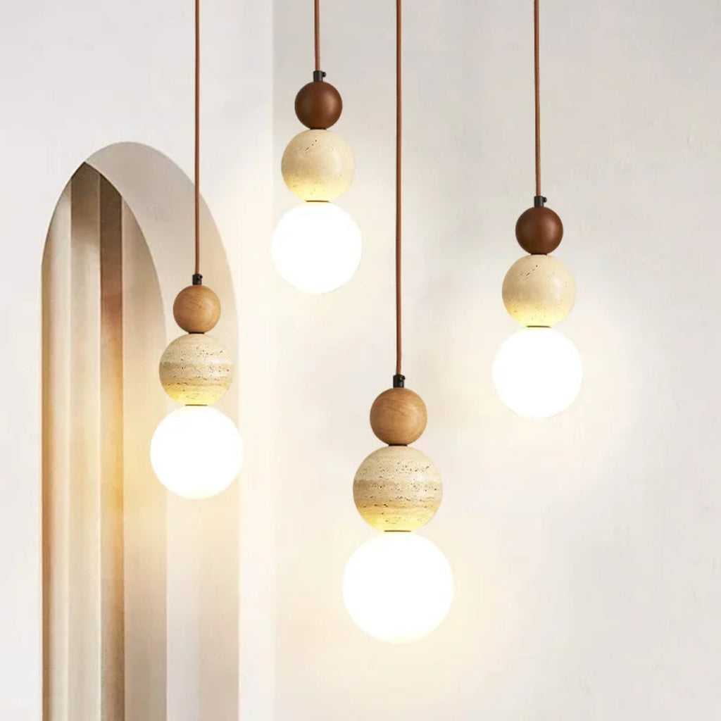Modern pendant lights with wooden spherical fixtures on a neutral background