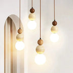 Modern pendant lights with wooden spherical fixtures on a neutral background