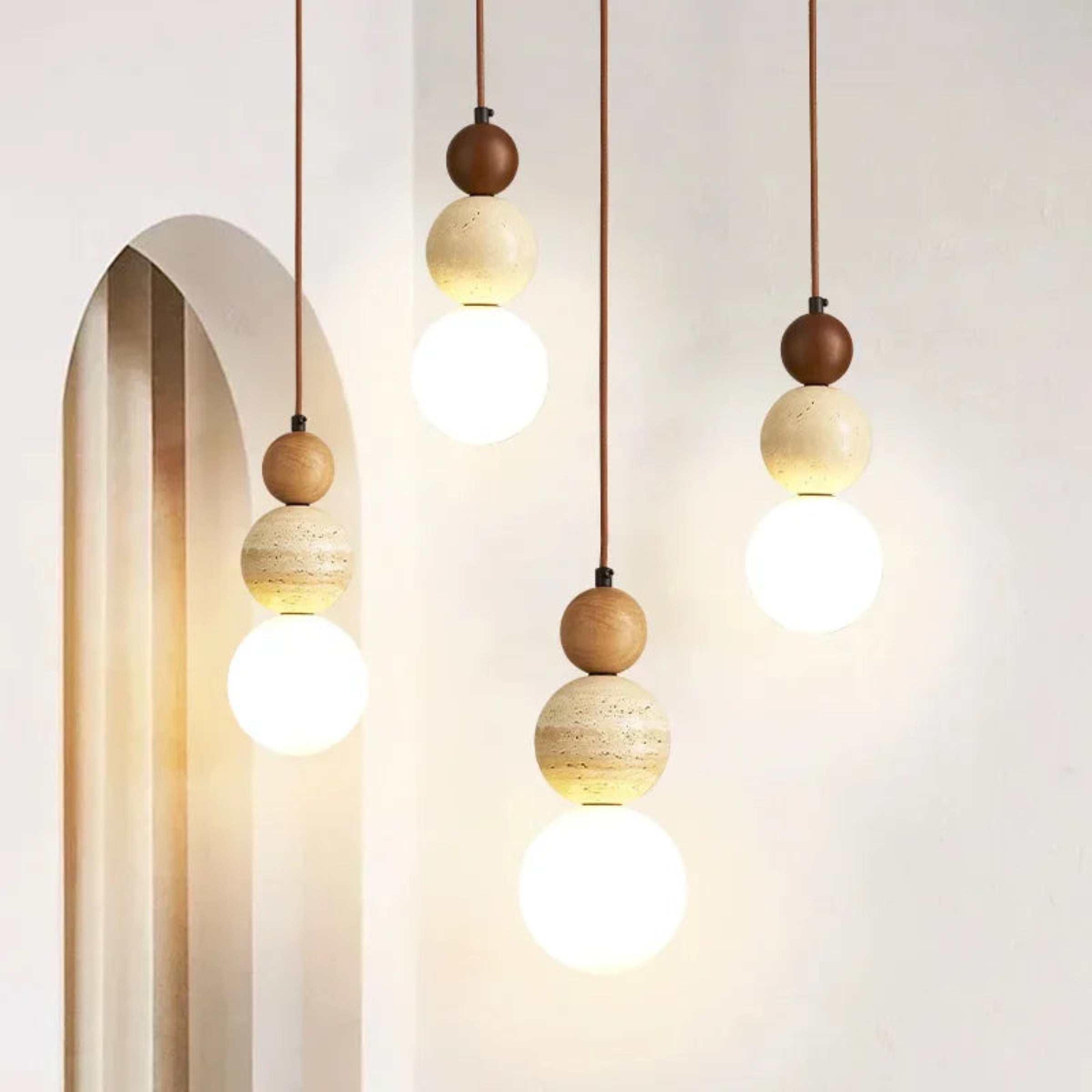 Modern pendant lights with wooden spherical fixtures on a neutral background