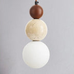 Pendant light with three spherical shades on a gray background