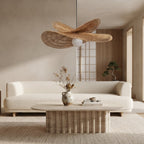 A modern, minimalist living room featuring a cream-colored sofa, a low ribbed wooden coffee table, a woven rug, and a distinctive wavy woven pendant light hanging from the ceiling.