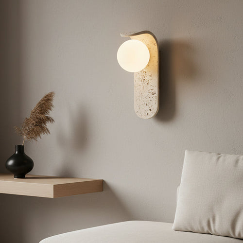 Wall-mounted light fixture with a textured concrete-like finish on a plain background