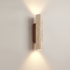 Wall-mounted cylindrical light fixture on a plain wall