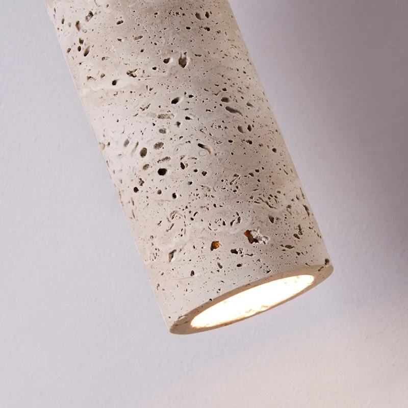 Cylindrical concrete light fixture on a gray background