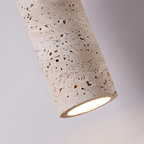 Cylindrical concrete light fixture on a gray background