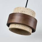 Pendant light with concrete base and bronze metal ring on a gray background