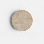 Round beige stone coaster on a white background