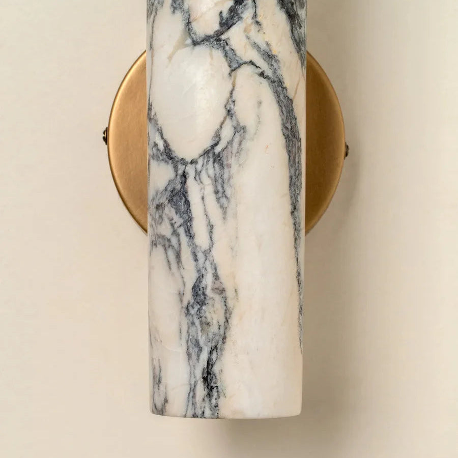 Marble-patterned wall sconce with gold frame on a beige background