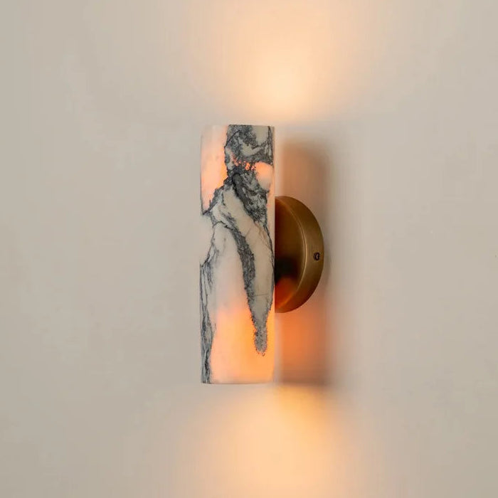 Wall-mounted light fixture with marble-like design on a neutral background