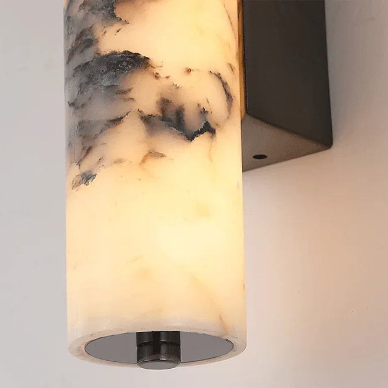 Wall-mounted light fixture with marble-like design on a neutral background