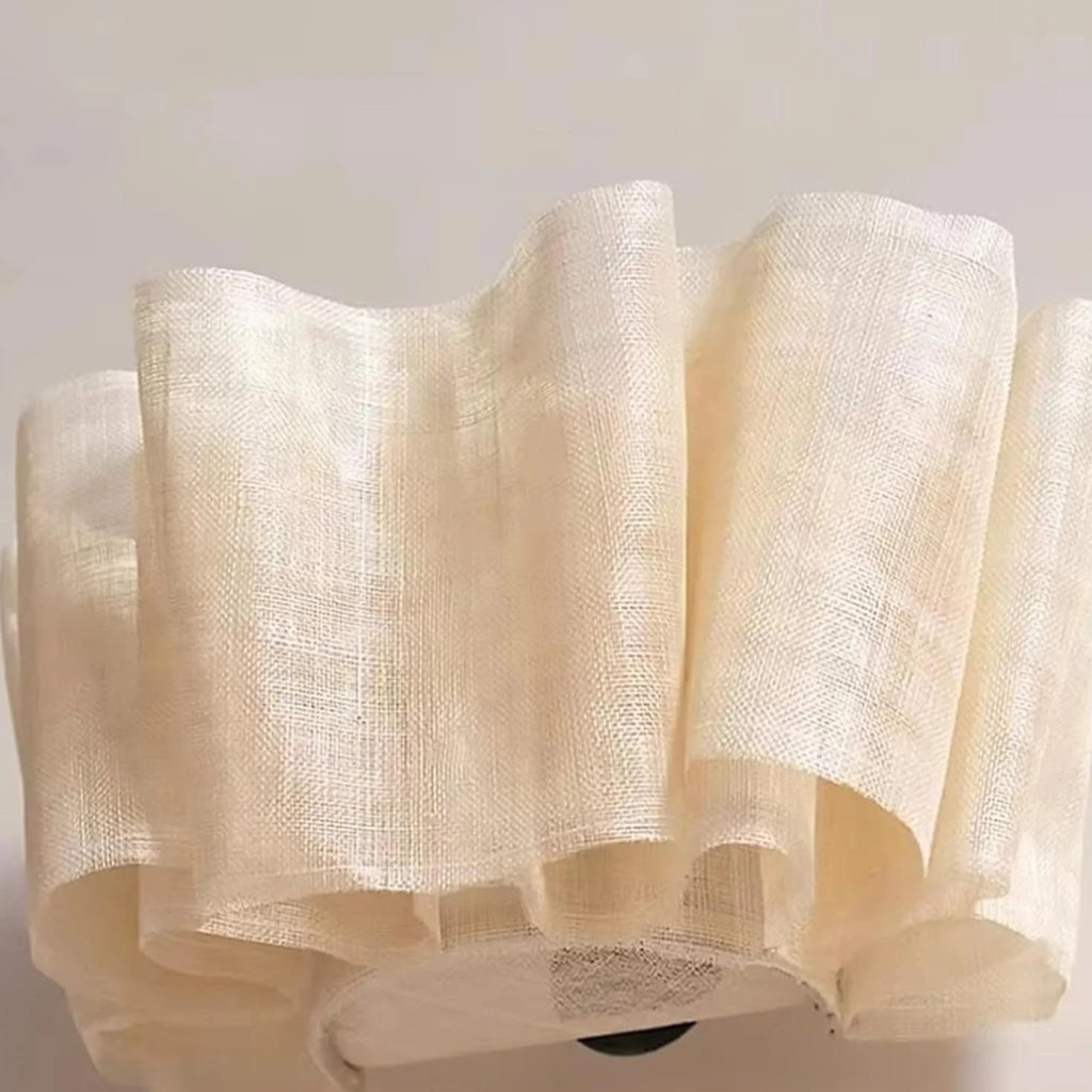 Beige textured fabric roll on a light gray background