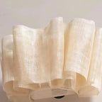 Beige textured fabric roll on a light gray background