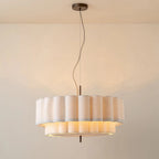 Ceiling light fixture with a textured lampshade on a plain background