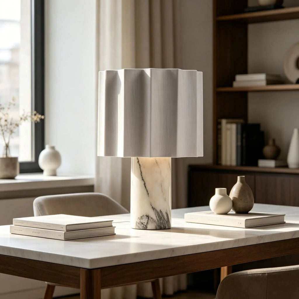 Marble lamp on a table with books and decorative items in a room setting