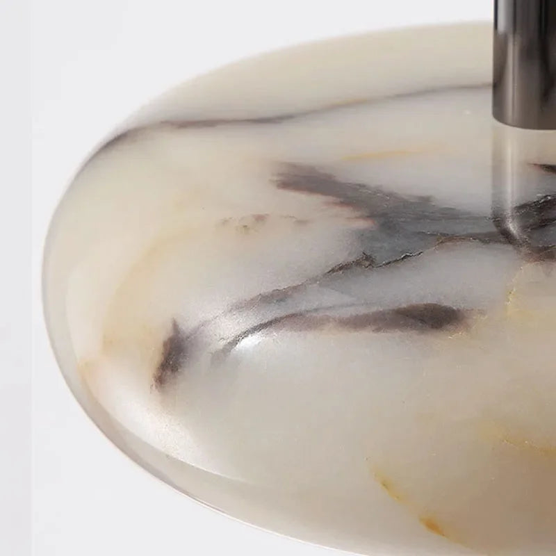 Close-up of a marble-patterned object with a metallic handle on a white background