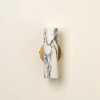 Marble-patterned wall sconce on a beige background