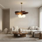 Modern living room with a ceiling fan light fixture, white sofa, and wooden coffee table.