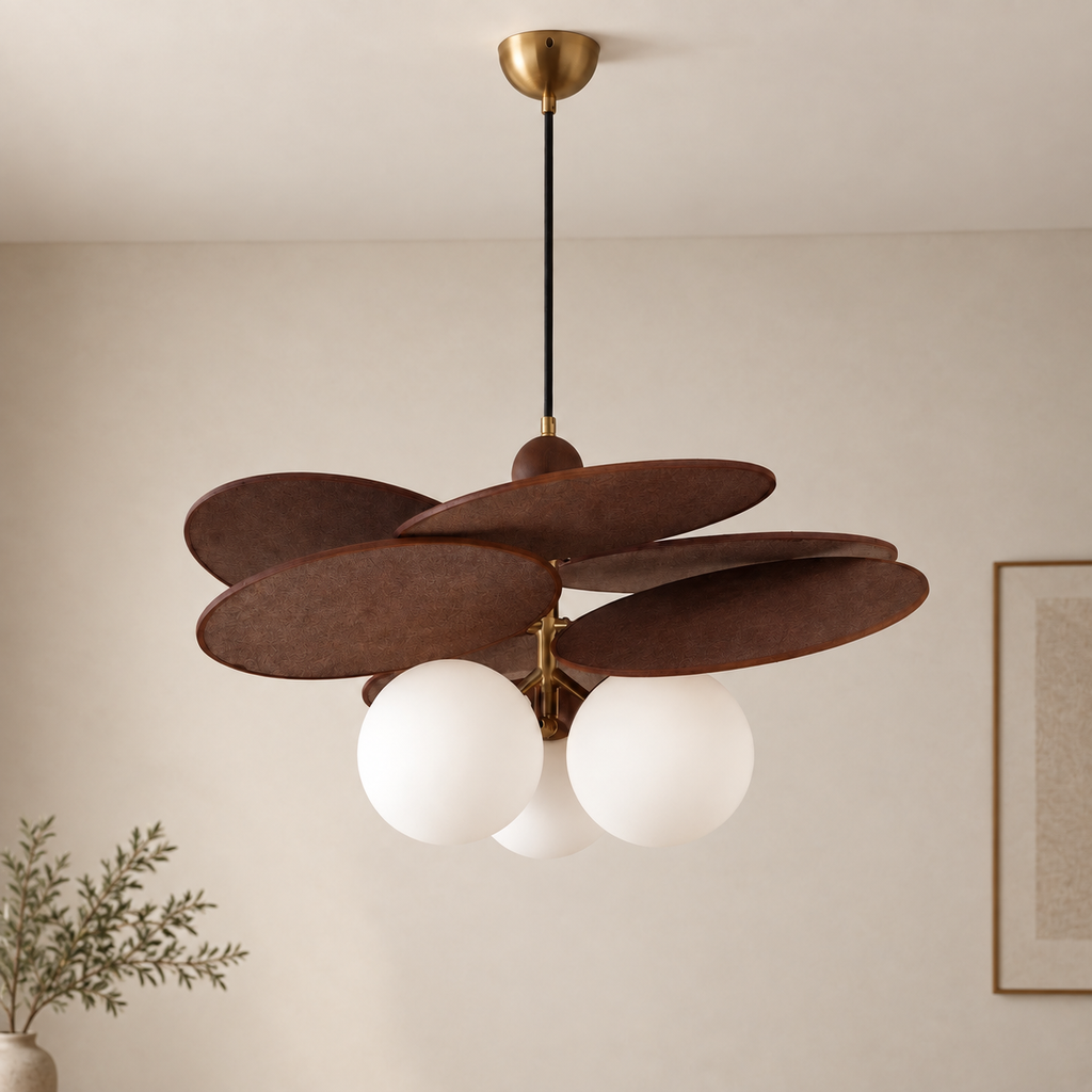 A modern pendant light fixture with five overlapping dark brown wooden shades and three white frosted glass globes, hanging from a black cord with a brass ceiling canopy in a neutral room.