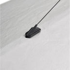 Black magnetic strip with a cable on a white background